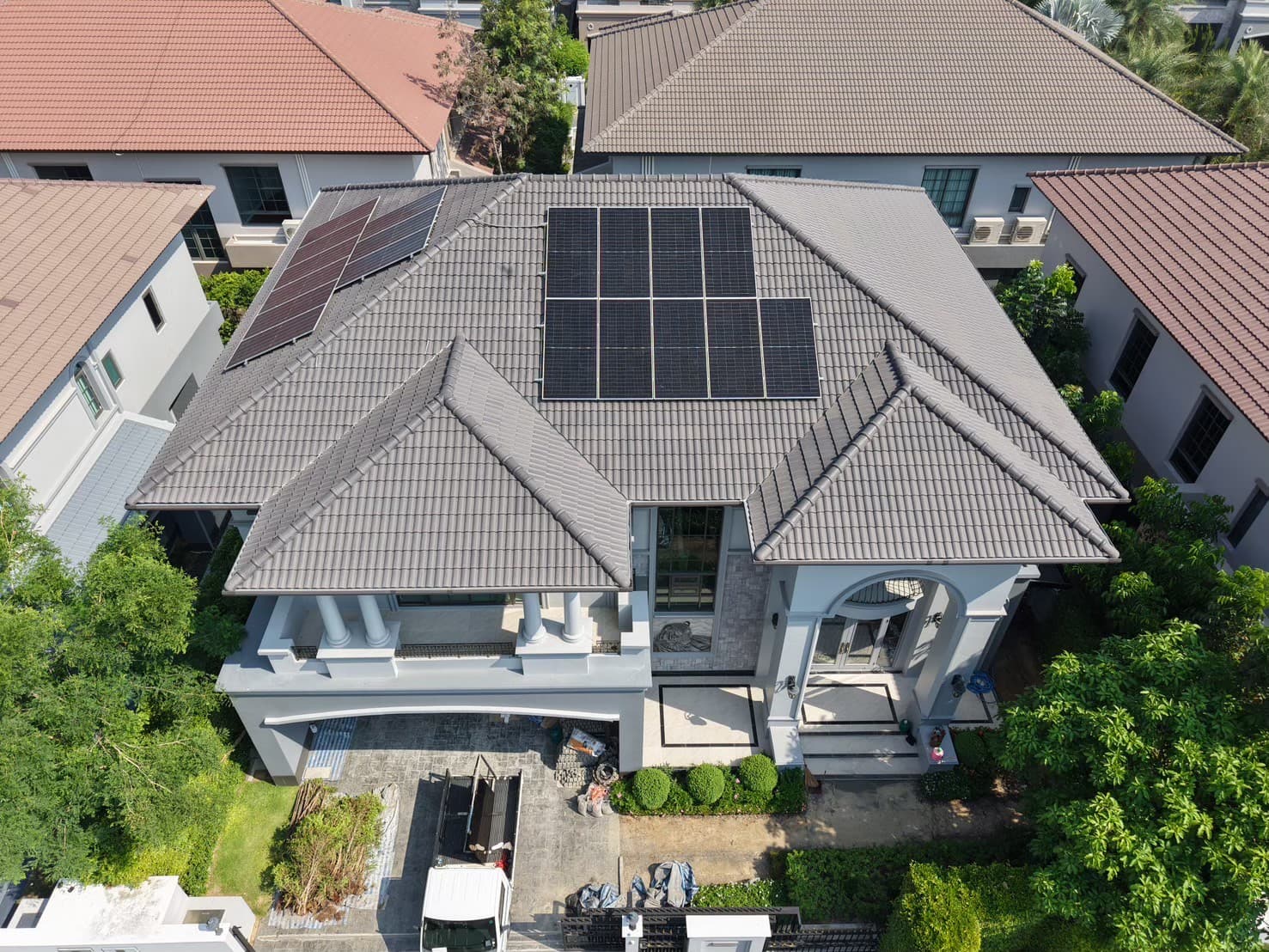 Modern architectural house with solar panels during golden hour